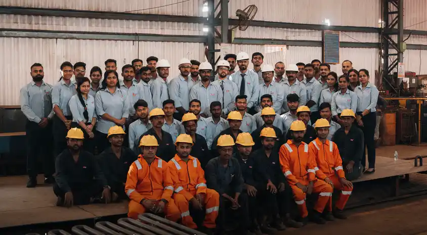 Group of professional engineers and plant operators at a power plant site.