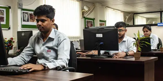 Candidates practicing on computers during an engineering simulation training program.