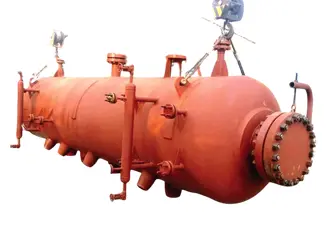 Large industrial horizontal pressure vessel with nozzles and bolted flange assembly.