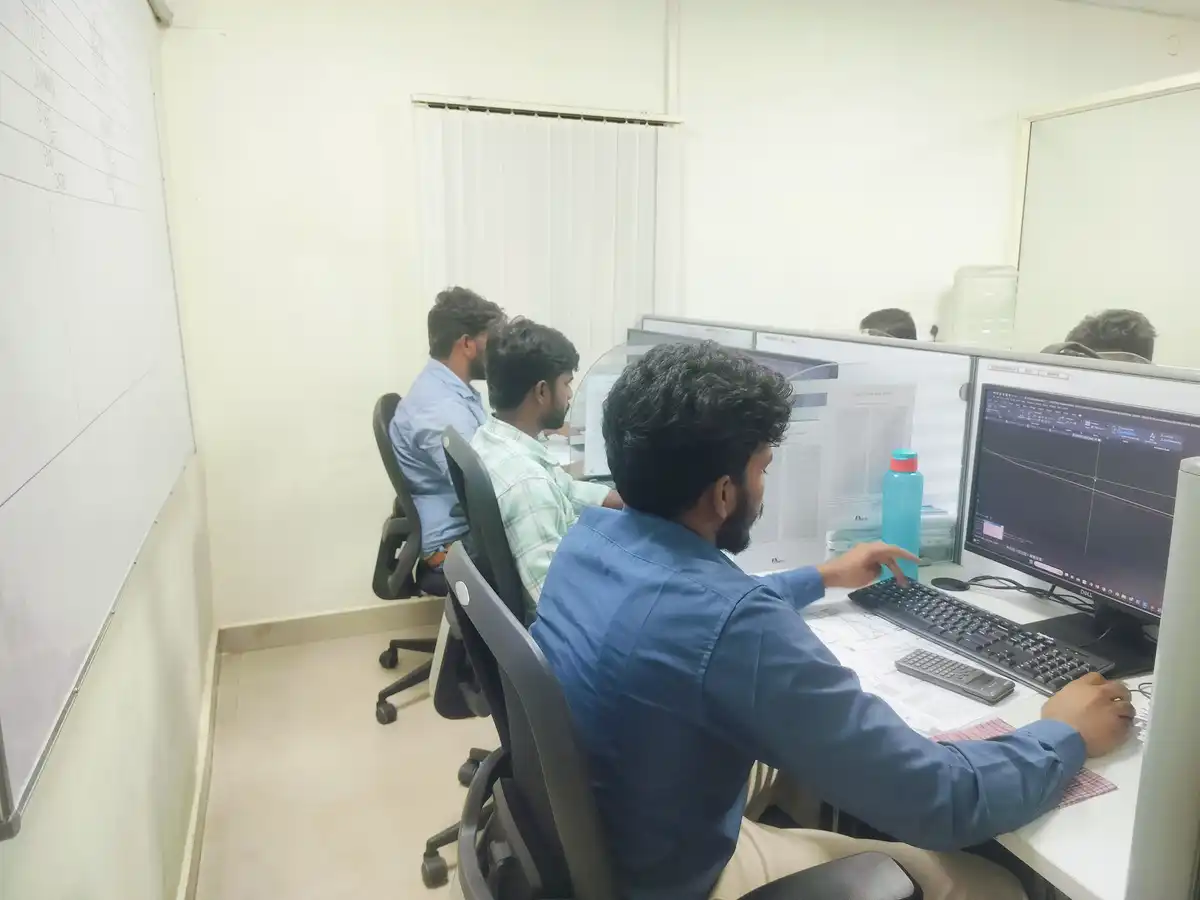 Engineers working at computers on industrial project planning and coordination.