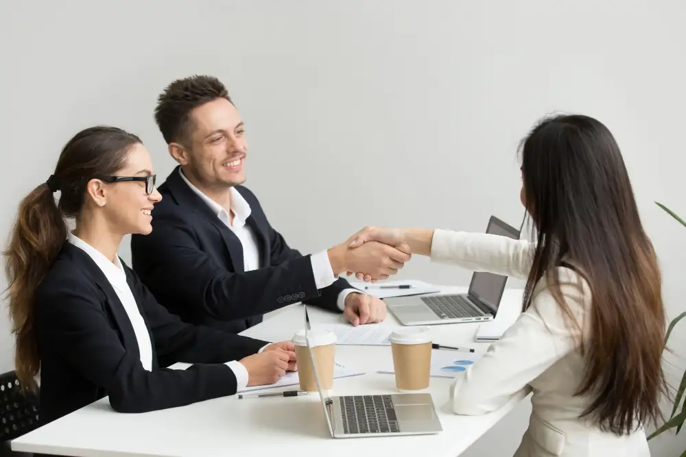 Job interview and professional handshake for recruitment and placement services.